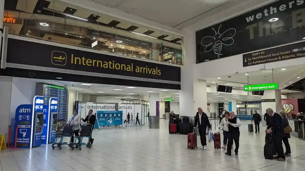 Passengers and airport staff inside London Gatwick Airport’s international arrivals area.