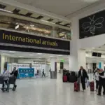 Passengers and airport staff inside London Gatwick Airport’s international arrivals area.