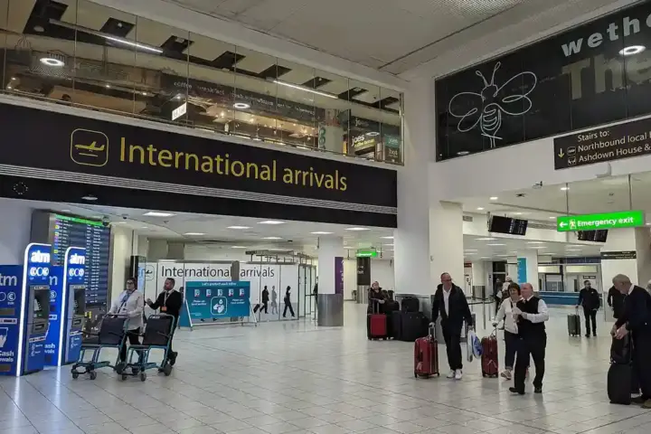 Passengers and airport staff inside London Gatwick Airport’s international arrivals area.