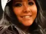 Nicole Snooki Polizzi photographed at a public event wearing a winter hat and smiling.