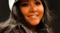Nicole Snooki Polizzi photographed at a public event wearing a winter hat and smiling.