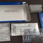 Diagnostic rapid test cassette and buffer solution vial arranged on a laboratory preparation surface