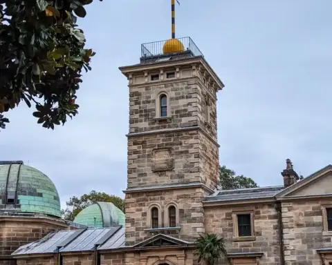 Historic sandstone building of Sydney Observatory on Observatory Hill against an open sky