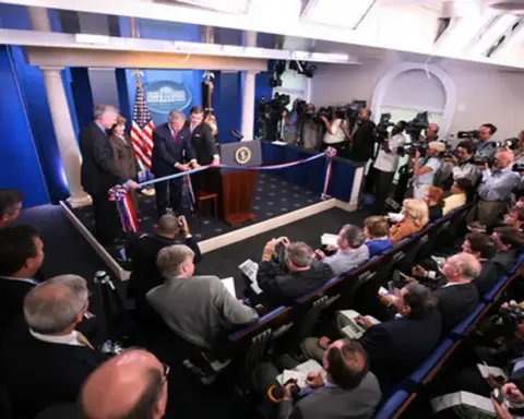 The James S. Brady Press Briefing Room inside the White House showing the official briefing lectern and assigned correspondent seating rows