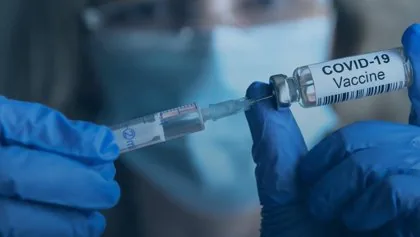 Close-up photograph of a vaccine vial and syringe prepared for an immunization campaign.
