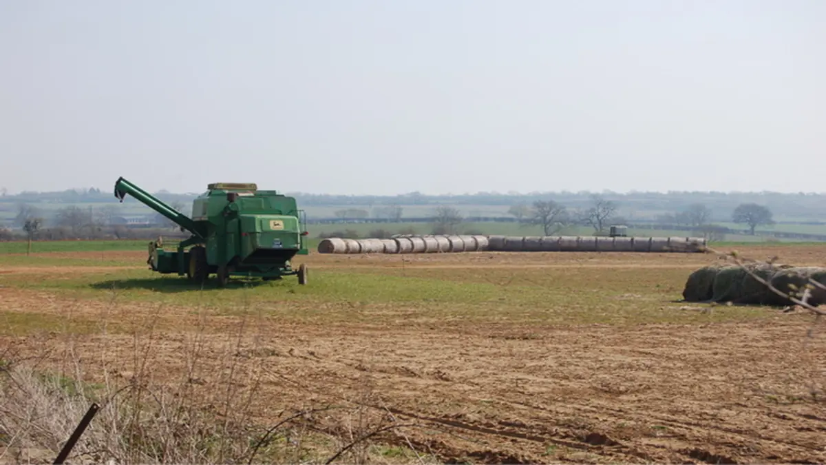 A heavy agricultural combine harvester harvesting grain crops
