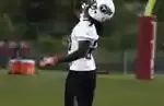 Chris Johnson running on a football field in a Tennessee Titans uniform during NFL play.