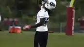 Chris Johnson running on a football field in a Tennessee Titans uniform during NFL play.