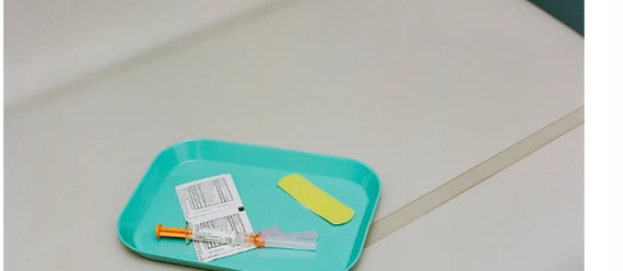 Healthcare practitioner administering a vaccination to a patient