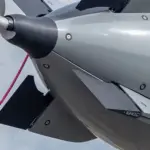 The 19-foot autonomous Dive-LD undersea robot suspended during deployment operations showing its cylindrical titanium and syntactic foam hull.