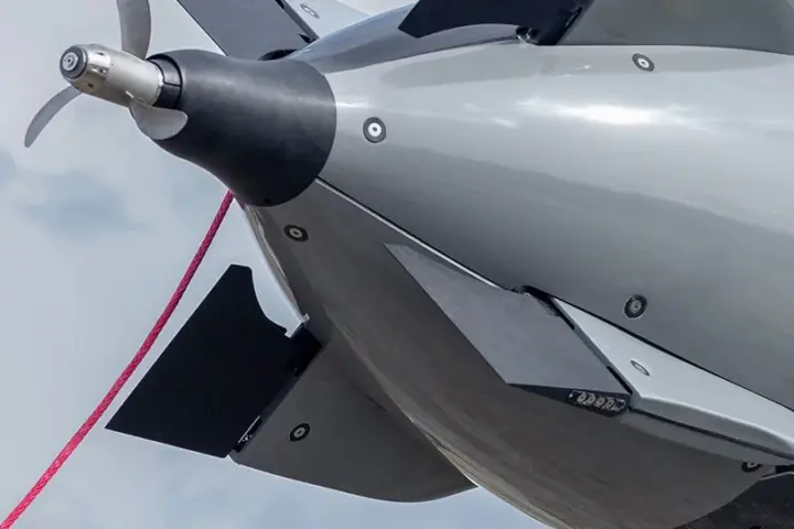 The 19-foot autonomous Dive-LD undersea robot suspended during deployment operations showing its cylindrical titanium and syntactic foam hull.