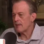 Billy Gardell speaking into a microphone during the Breaking Bread with Tom Papa podcast