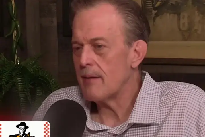Billy Gardell speaking into a microphone during the Breaking Bread with Tom Papa podcast
