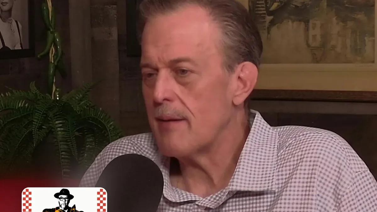 Billy Gardell speaking into a microphone during the Breaking Bread with Tom Papa podcast