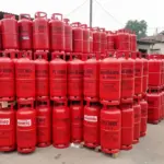 Red liquefied petroleum gas cylinders stacked at a commercial distribution point in India.