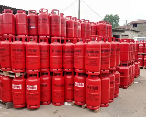 Red liquefied petroleum gas cylinders stacked at a commercial distribution point in India.