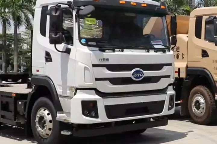 White BYD heavy electric truck displayed outdoors