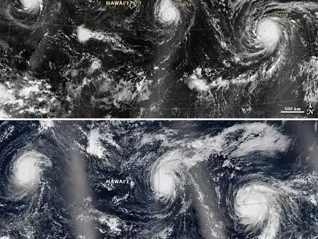 High-resolution satellite view from space showing defined hurricane eye walls and swirling cloud bands over the Pacific Ocean.