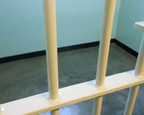 Representative prison bars photograph used as context for federal custody and reentry reporting
