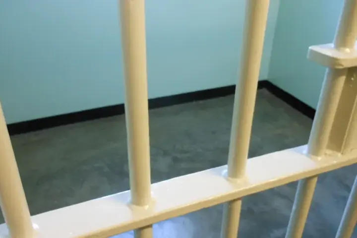 Representative prison bars photograph used as context for federal custody and reentry reporting