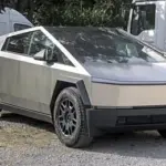 Silver Tesla Cybertruck photographed from the front in an outdoor parking area.