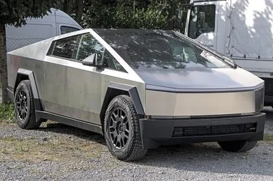 Silver Tesla Cybertruck photographed from the front in an outdoor parking area.