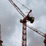 Heavy tower construction cranes operating across a major high-rise residential building site in London