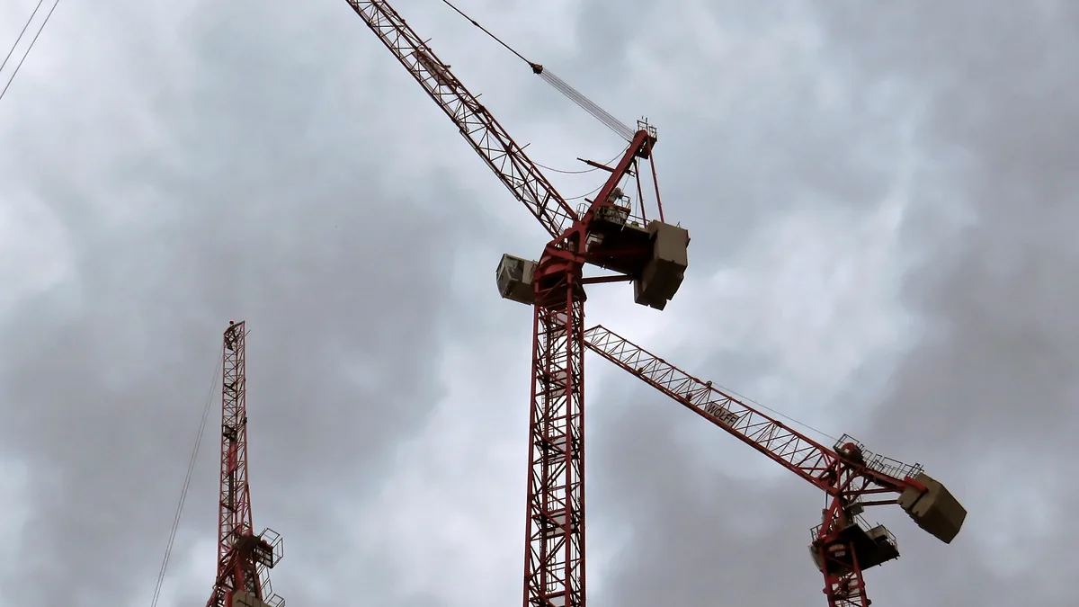 Heavy tower construction cranes operating across a major high-rise residential building site in London