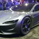 Red second-generation Tesla Roadster prototype vehicle displayed on stage
