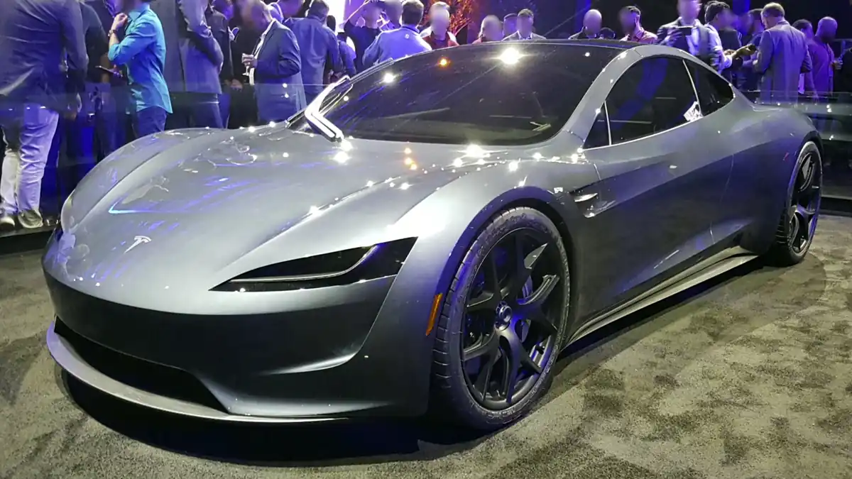 Red second-generation Tesla Roadster prototype vehicle displayed on stage