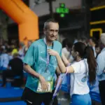 Runner finishes a race at a local running event, contextual image for the Sydney Marathon energy gel litter article