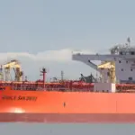 Large crude oil tanker berthed alongside a marine export terminal.