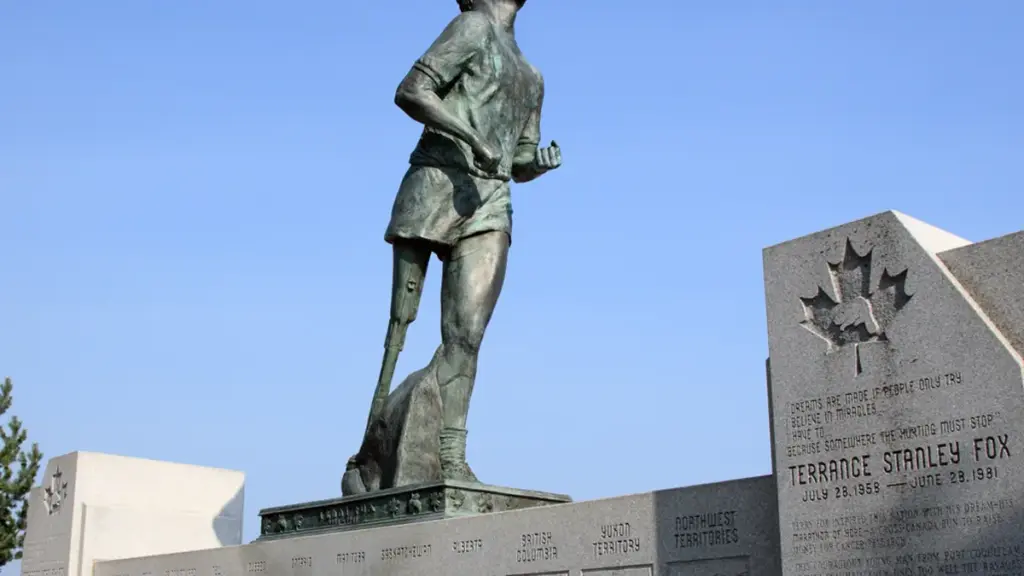 Bronze statue of Terry Fox in mid-stride on a stone pedestal overlooking Thunder Bay and the Trans-Canada Highway.
