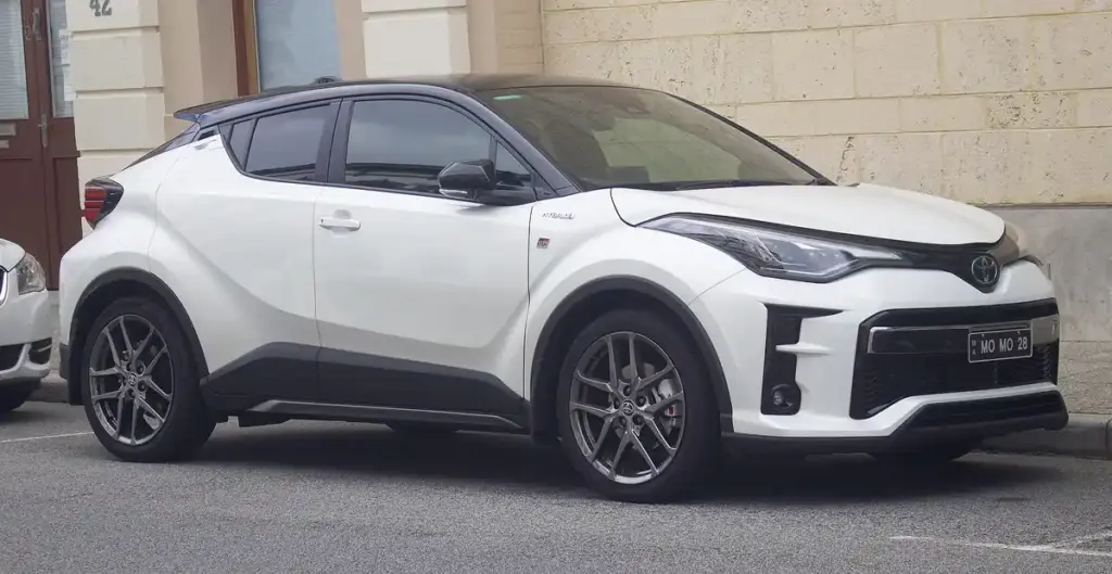 Front view of a dark-toned Toyota C-HR vehicle parked on a paved street