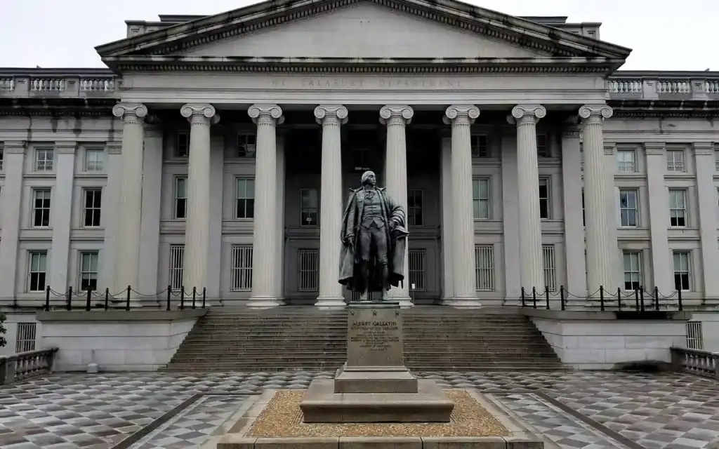 U.S. Treasury Building and Albert Gallatin statue in Washington, D.C., photographed from street level.