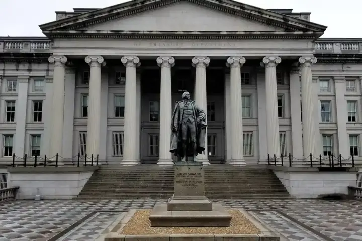 U.S. Treasury Building and Albert Gallatin statue in Washington, D.C., photographed from street level.
