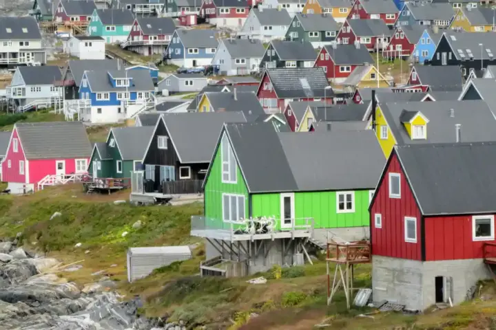 Multicolored coastal houses clustered along the waterfront in Nuuk, Greenland.
