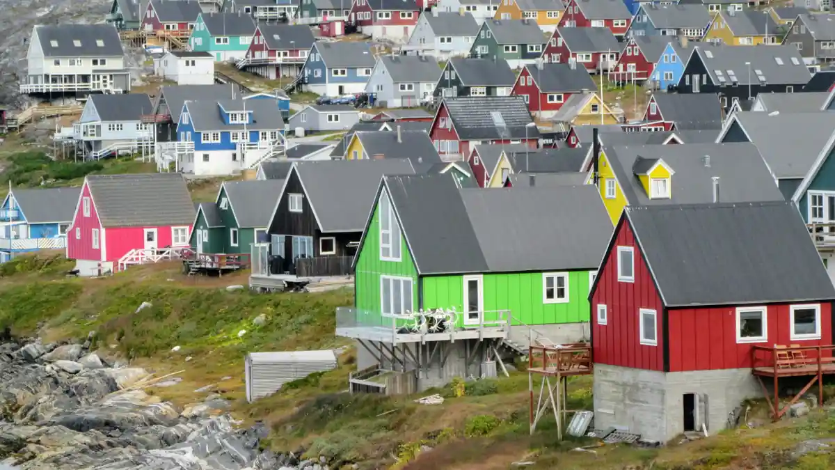 Multicolored coastal houses clustered along the waterfront in Nuuk, Greenland.