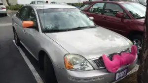 A rideshare vehicle with Uber, Lyft, and Sidecar branding, representing the gig economy transportation services at the center of the $40 million arbitration case.