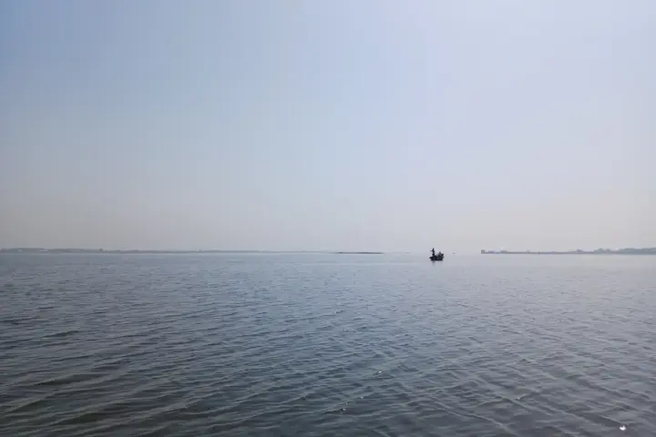 Wide expanse of Ujani reservoir water on the Bhima River with distant shores and open aquatic habitat.