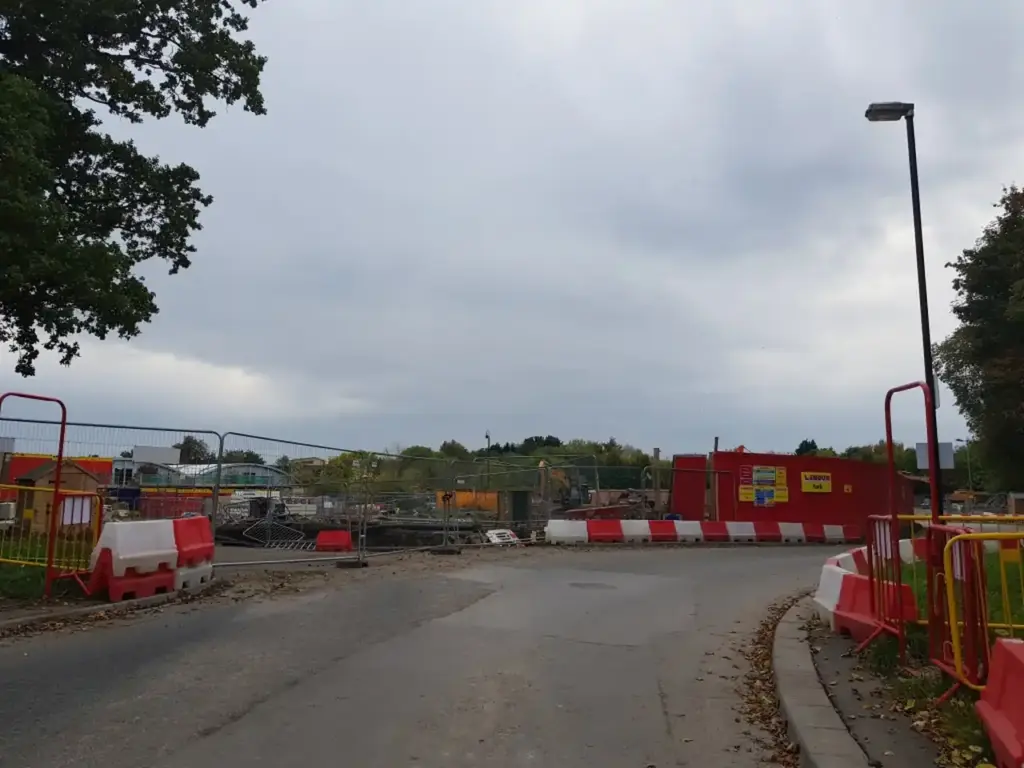 Active residential construction site showing framework and foundation work for new housing development.