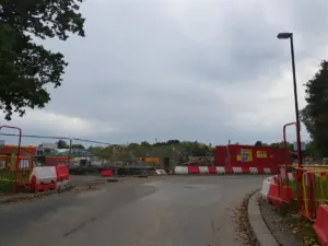 Active residential construction site showing framework and foundation work for new housing development.