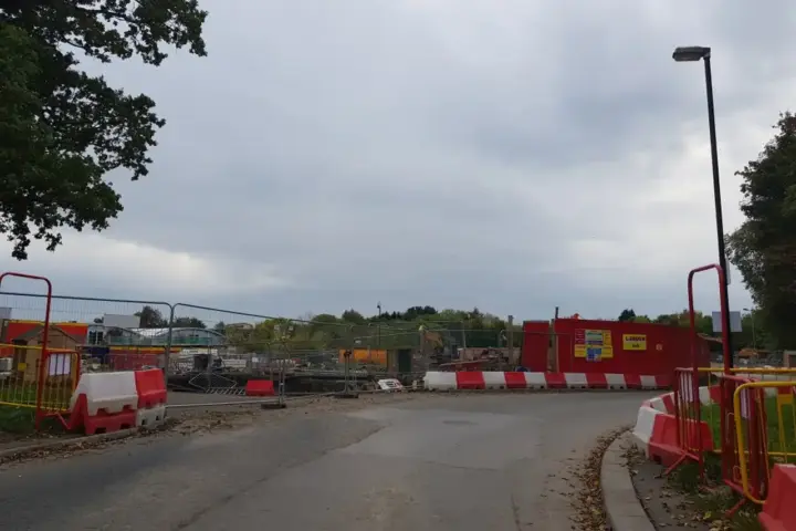 Active residential construction site showing framework and foundation work for new housing development.