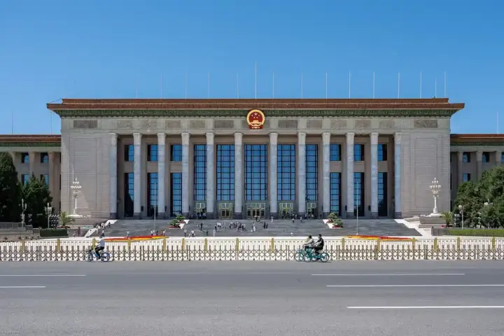 Wide exterior photograph of the Great Hall of the People building in Beijing under an open sky