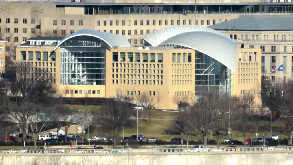 Exterior curved glass and limestone architecture of the United States Institute of Peace headquarters along Constitution Avenue in Washington, D.C.