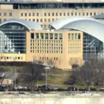 Exterior curved glass and limestone architecture of the United States Institute of Peace headquarters along Constitution Avenue in Washington, D.C.