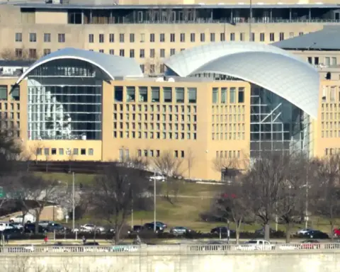 Exterior curved glass and limestone architecture of the United States Institute of Peace headquarters along Constitution Avenue in Washington, D.C.