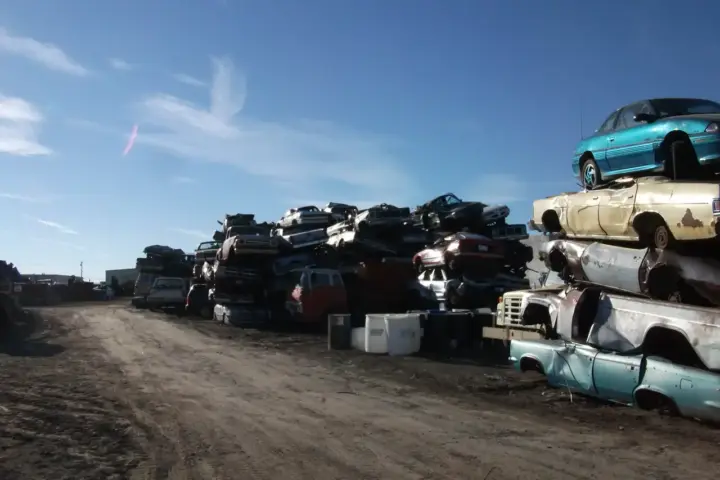 Cars awaiting shredding in a recycling yard, representing the vehicle recycling infrastructure behind India's EPR circular economy shift.