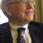 Close-up portrait photograph of investor Warren Buffett speaking during a public appearance.
