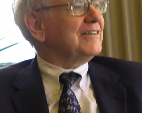 Close-up portrait photograph of investor Warren Buffett speaking during a public appearance.